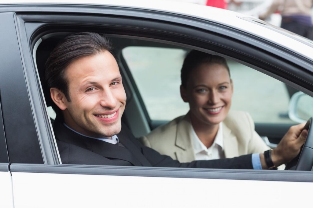 man and a lady is on the car